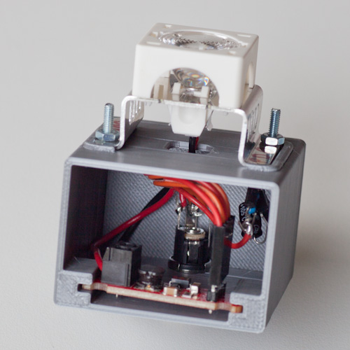 The lamp without the outer oak shell. At the top is the LED in its mounting bracket below a lens. Below it is a 3D-printed box with the LED driver and other components inside.